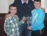 Paul Doherty presents Odhran Mc Garrell and Callum Scullion SW Football Under 10 A Championship Cup